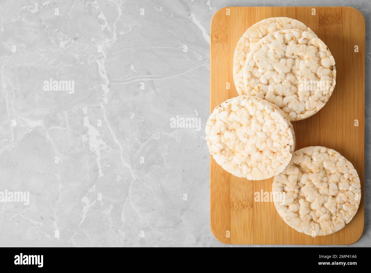 Crunchy rice cakes on grey marble table, top view. Space for text Stock Photo