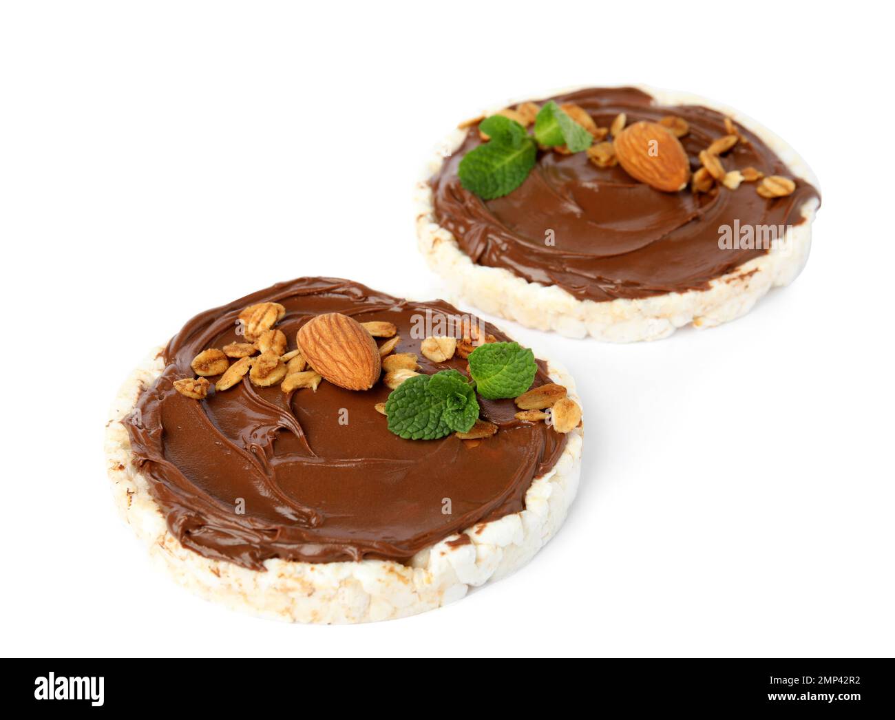 Puffed rice cakes with chocolate spread, nuts and mint isolated on