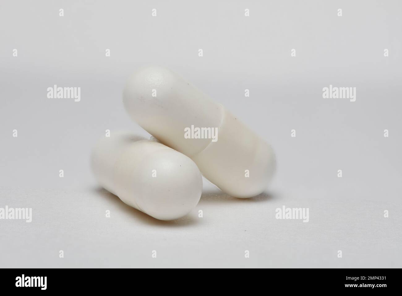 two pills white capsule medication nutrition chemical health doctor prescribe wellbeing clinic hospital Harley Street cut-out high resolution medicine Stock Photo