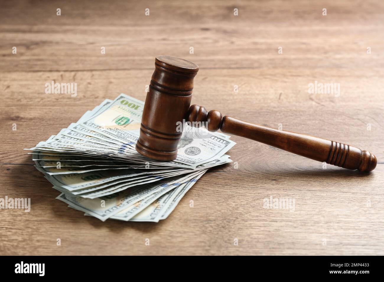 Dollar bills and gavel on wooden table. Bribe concept Stock Photo