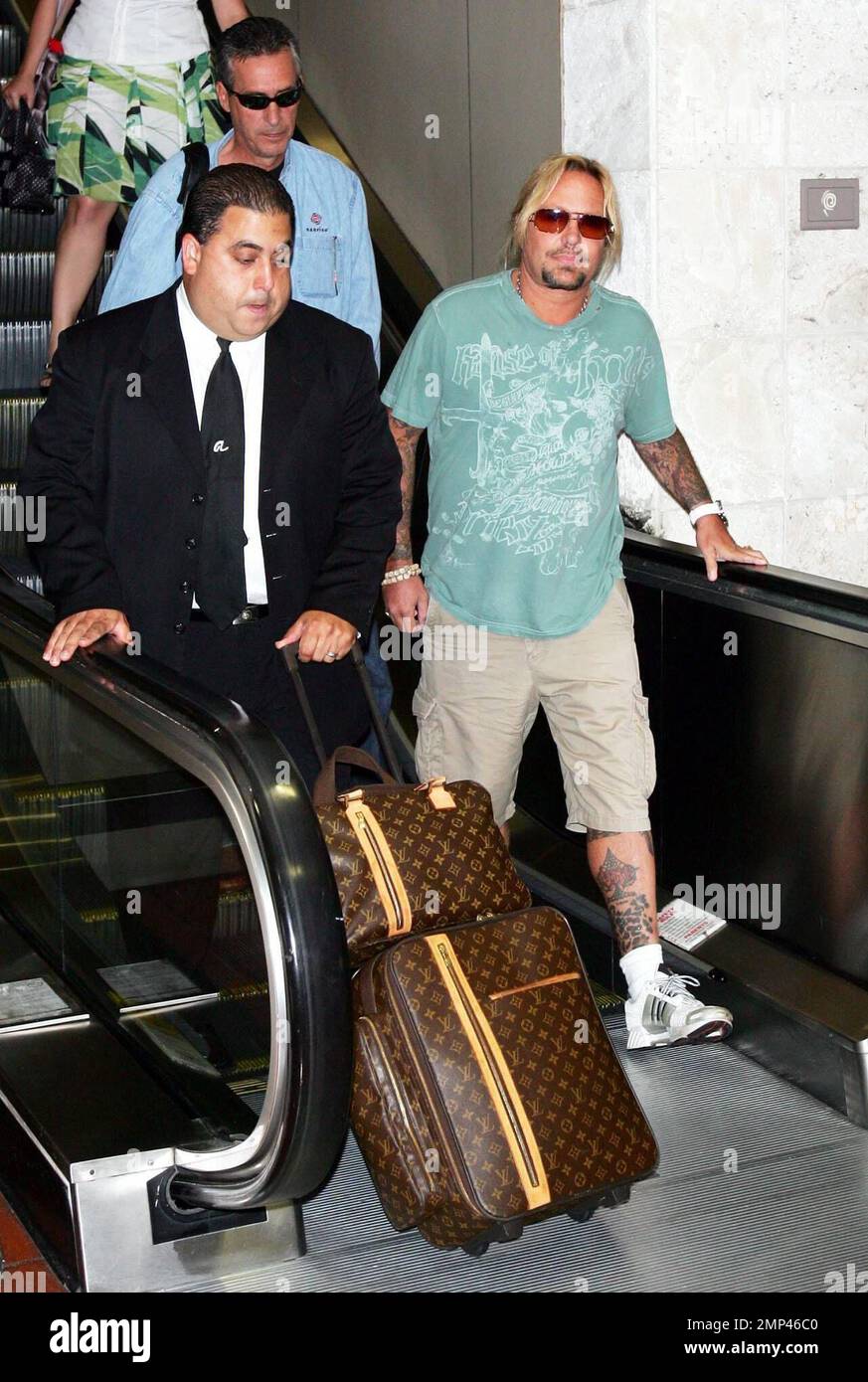 Exclusive!! Vince Neil arrives at Palm Beach International Airport and  strolls along with a bodyguard who carries his Louis Vuitton luggage. His  arrival is in advance of CrŸe Fest featuring Mštley CrŸe