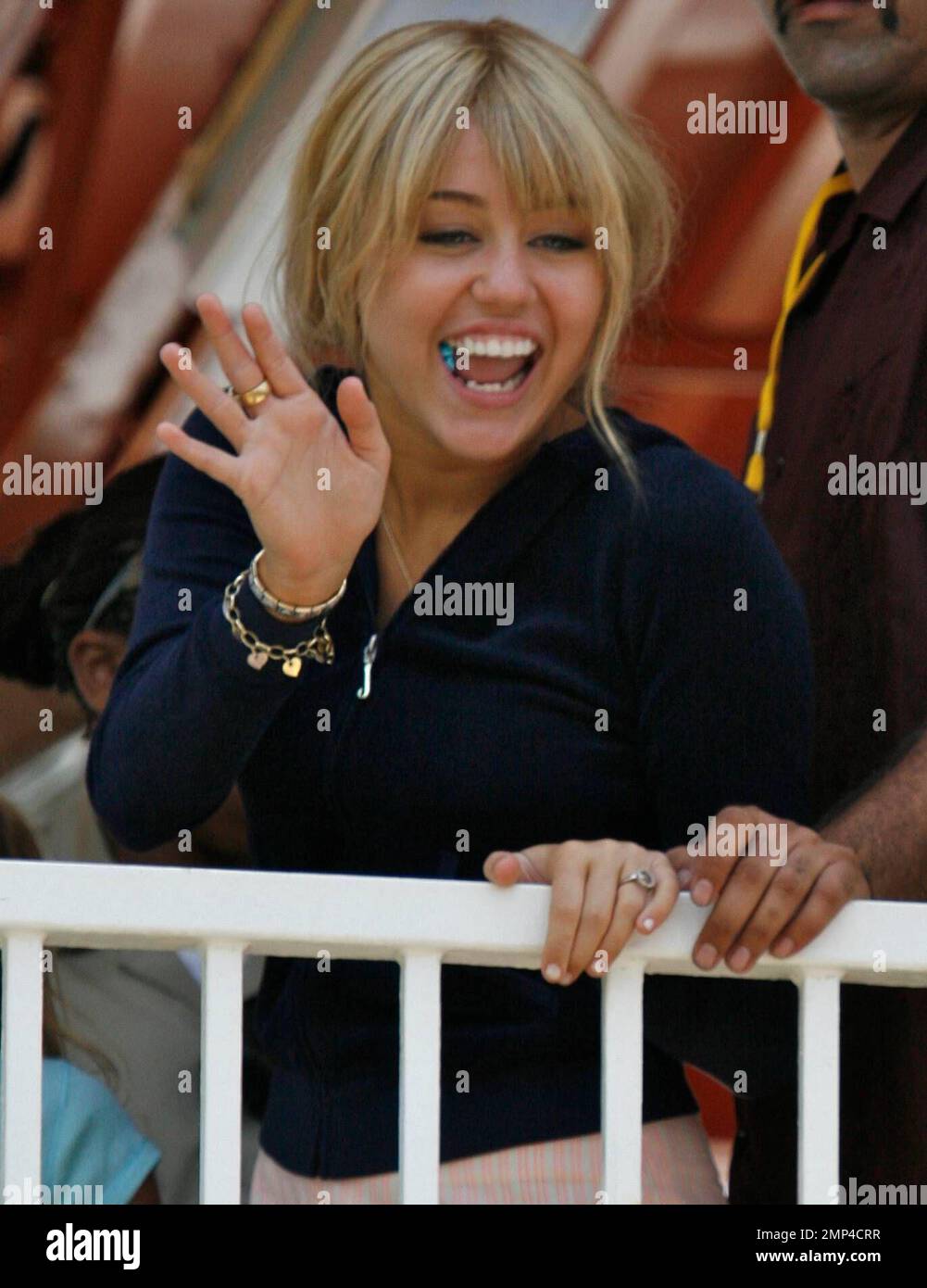 Miley Cyrus has fun on the rides with her sister (check) at the Santa