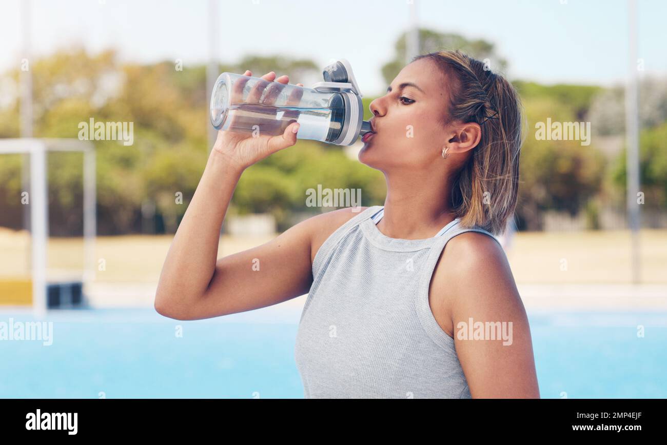 Water, thirsty and woman with a bottle after running, training