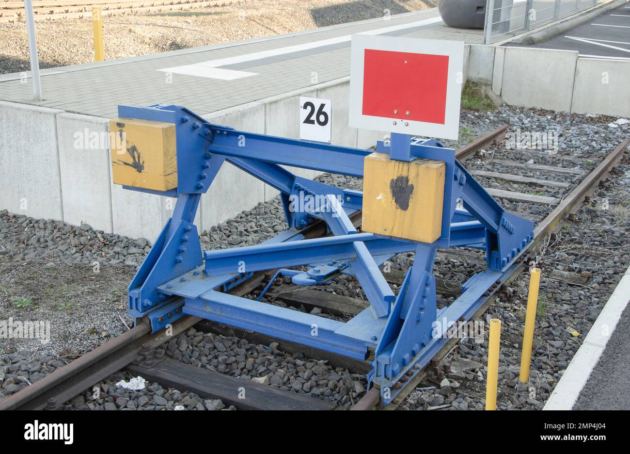 A buffer stop, also known as a buffer weir or buffer, is a form of track closure. It prevents a vehicle from rolling over the end of the track on dea Stock Photo