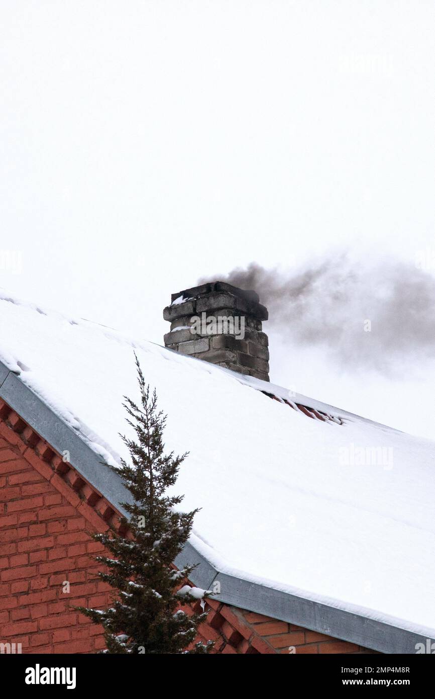 Black smoke from a chimney on the roof of the house Stock Photo - Alamy
