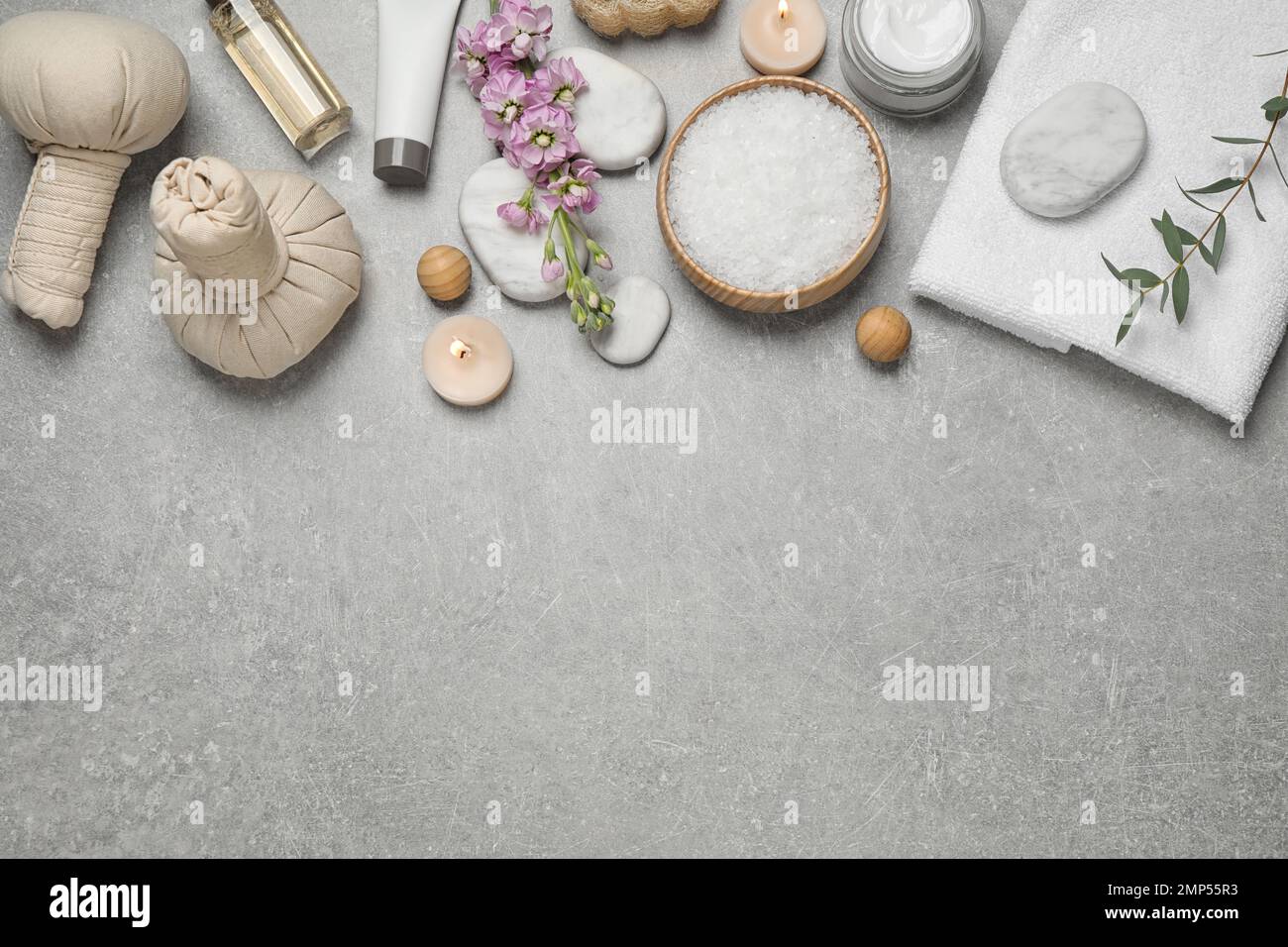 Flat lay composition with cosmetics on grey marble table, space for ...