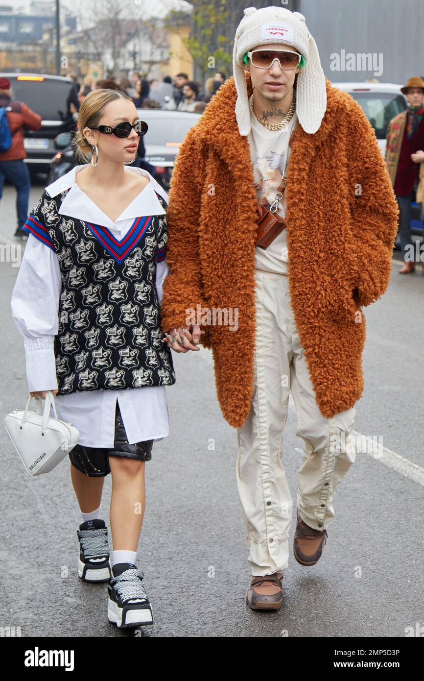 MILAN, ITALY - JANUARY 15, 2023: Woman and man with white shirt and gilet and brown fur coat before Etro fashion show, Milan Fashion Week street style Stock Photo