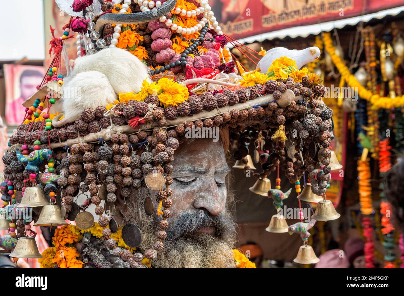 White ash covered sadhu with a hat decorated with Marigold garland necklaces, pearls and white rats, For editorial use only, Allahabad Kumbh Mela, Wor Stock Photo