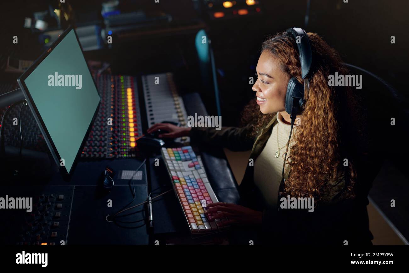 Woman, smile or musician headphones in computer music recording, sound engineering or song composition in studio. Producer, happy or DJ on technology Stock Photo