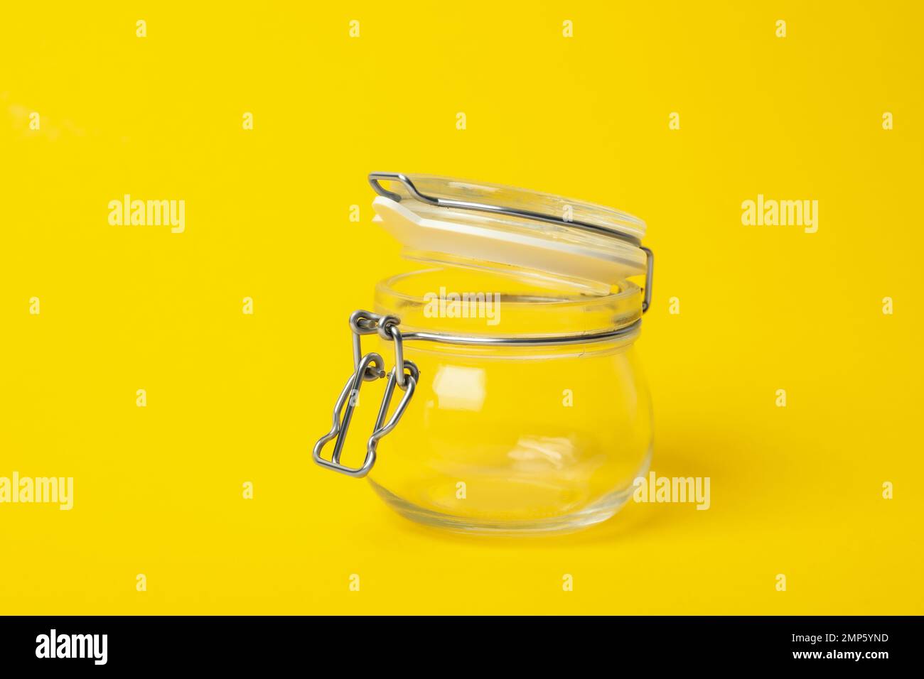 Open empty glass jar on yellow background Stock Photo Alamy