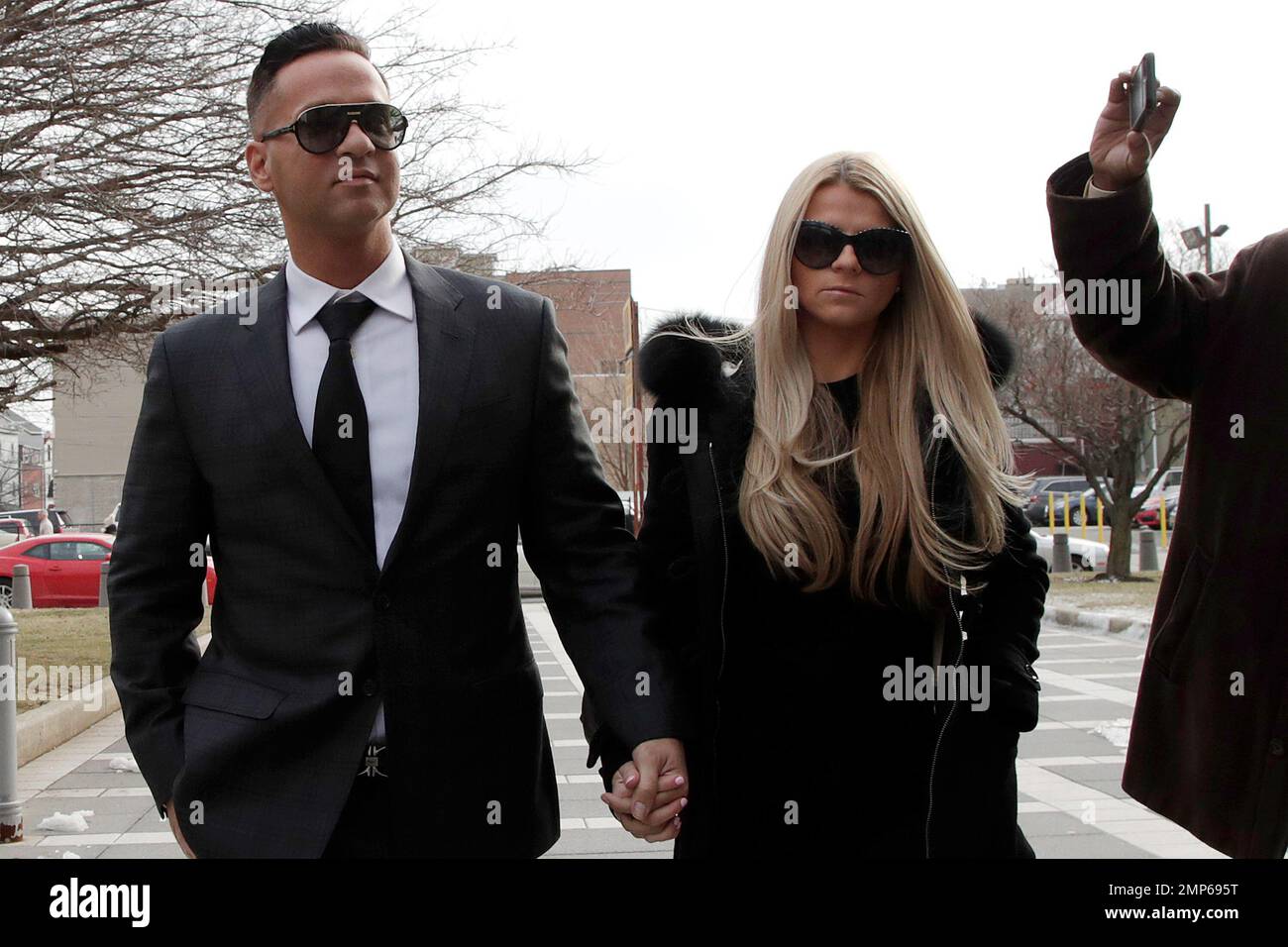Michael "The Situation" Sorrentino, left, one of the former stars of the  "Jersey Shore" reality TV show, walks with his fiancee Lauren Pesce while  arriving at the Martin Luther King, Jr., Federal