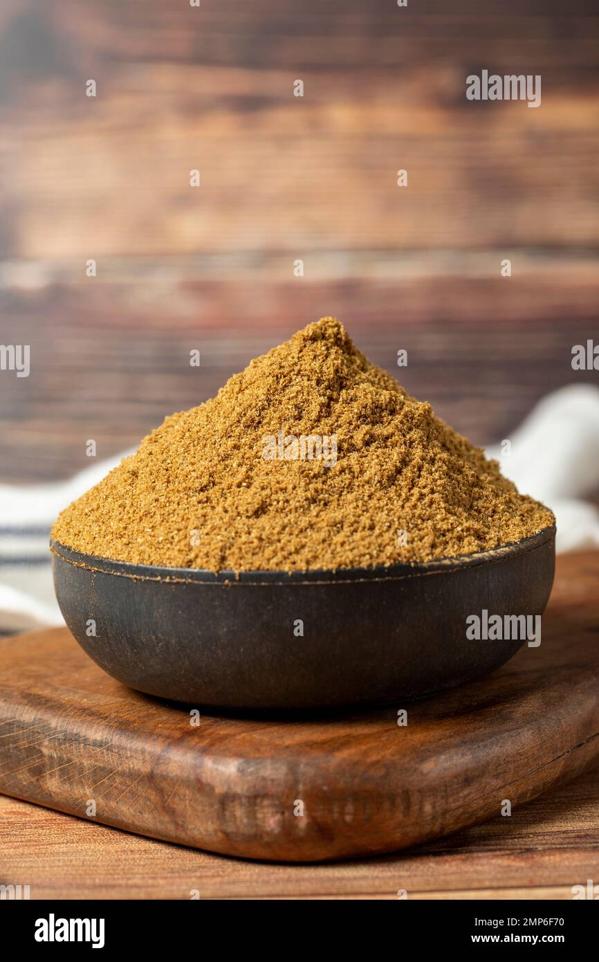 Powdered cumin spice. Cumin spice in bowl on wooden background. Dry
