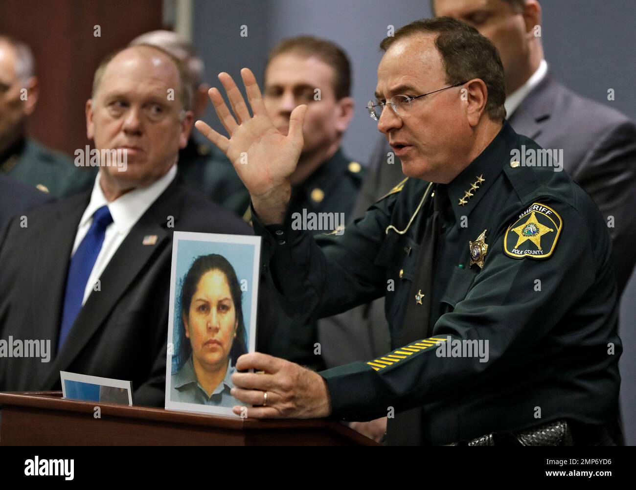 Polk County Sheriff Grady Judd, right, gestures as he holds up a ...
