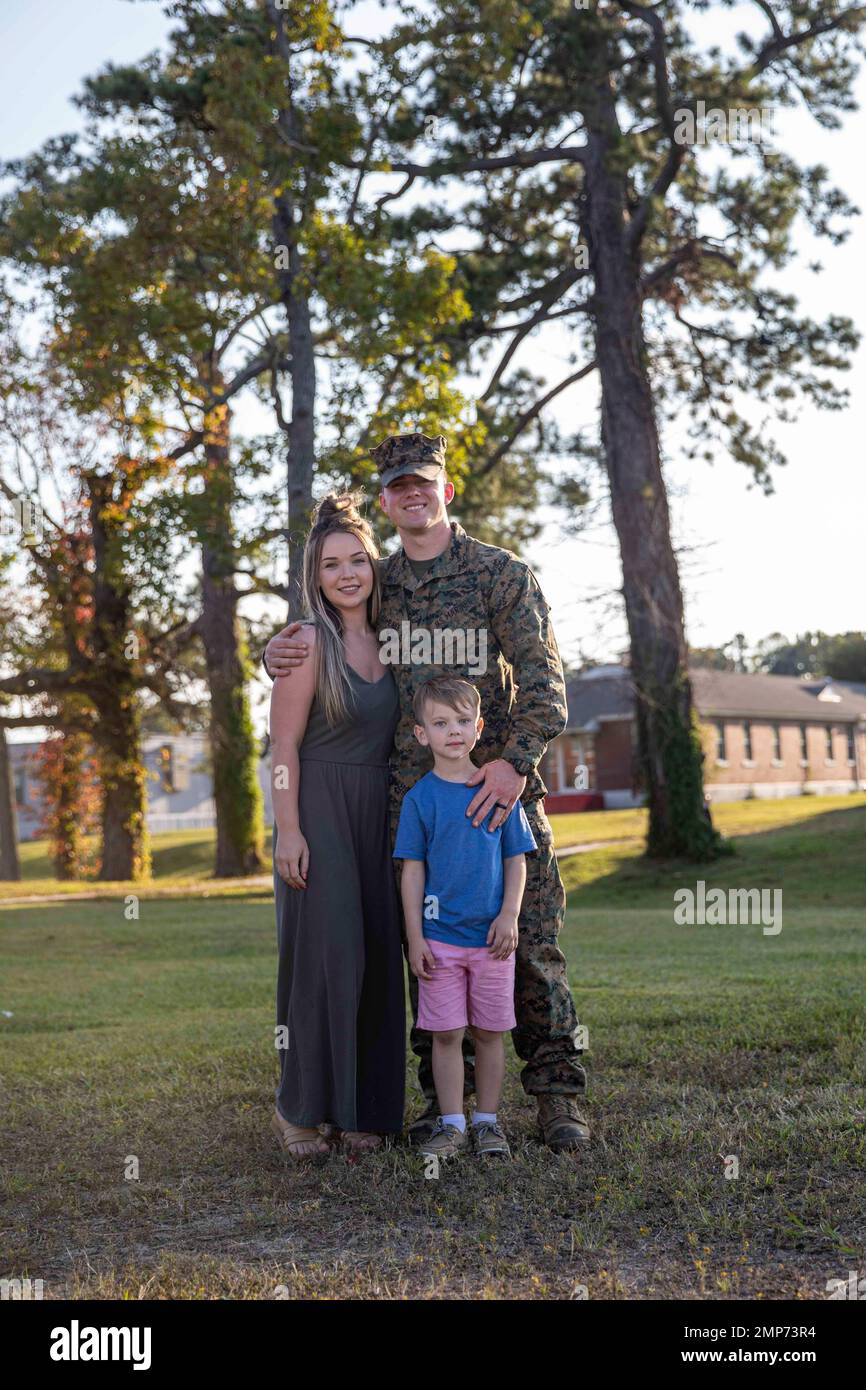 U.S. Marine Corps Lance Cpl. JohnPaul Comeaux, a machine gunner with Battalion Landing Team 2/6, 22nd Marine Expeditionary Unit (MEU), poses for a photo with his family during a homecoming aboard Camp Lejeune, North Carolina, Oct. 10, 2022. Marines and Sailors assigned to the 22nd MEU returned home after completing a seven-month deployment with the Kearsarge Amphibious Ready Group in the U.S. Naval Sixth Fleet area of operations. Stock Photo