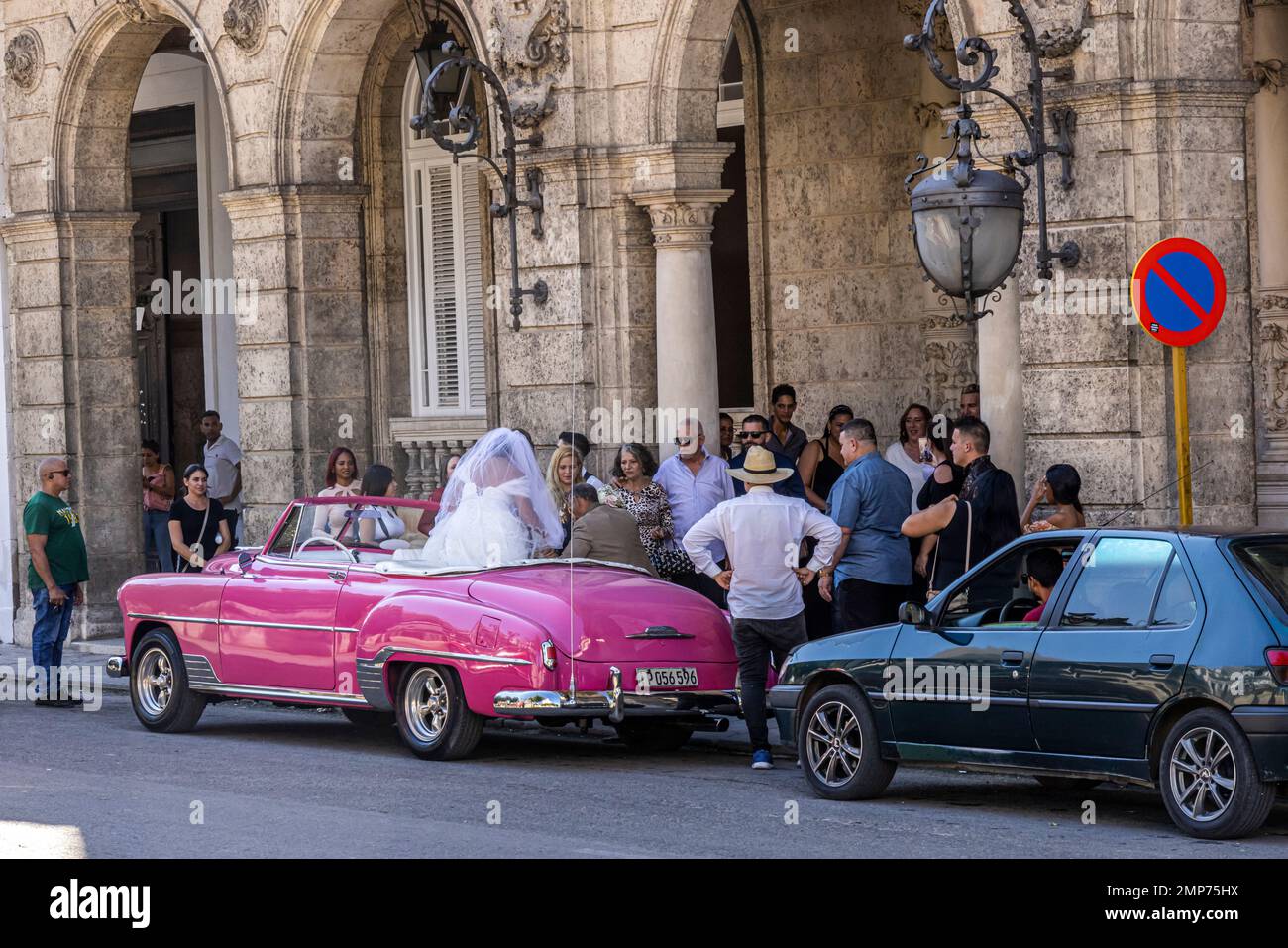 Bride alighting from Classic American car at Wedding Palace, Paseo de Marti, Central Havana, Havana, Cuba Stock Photo
