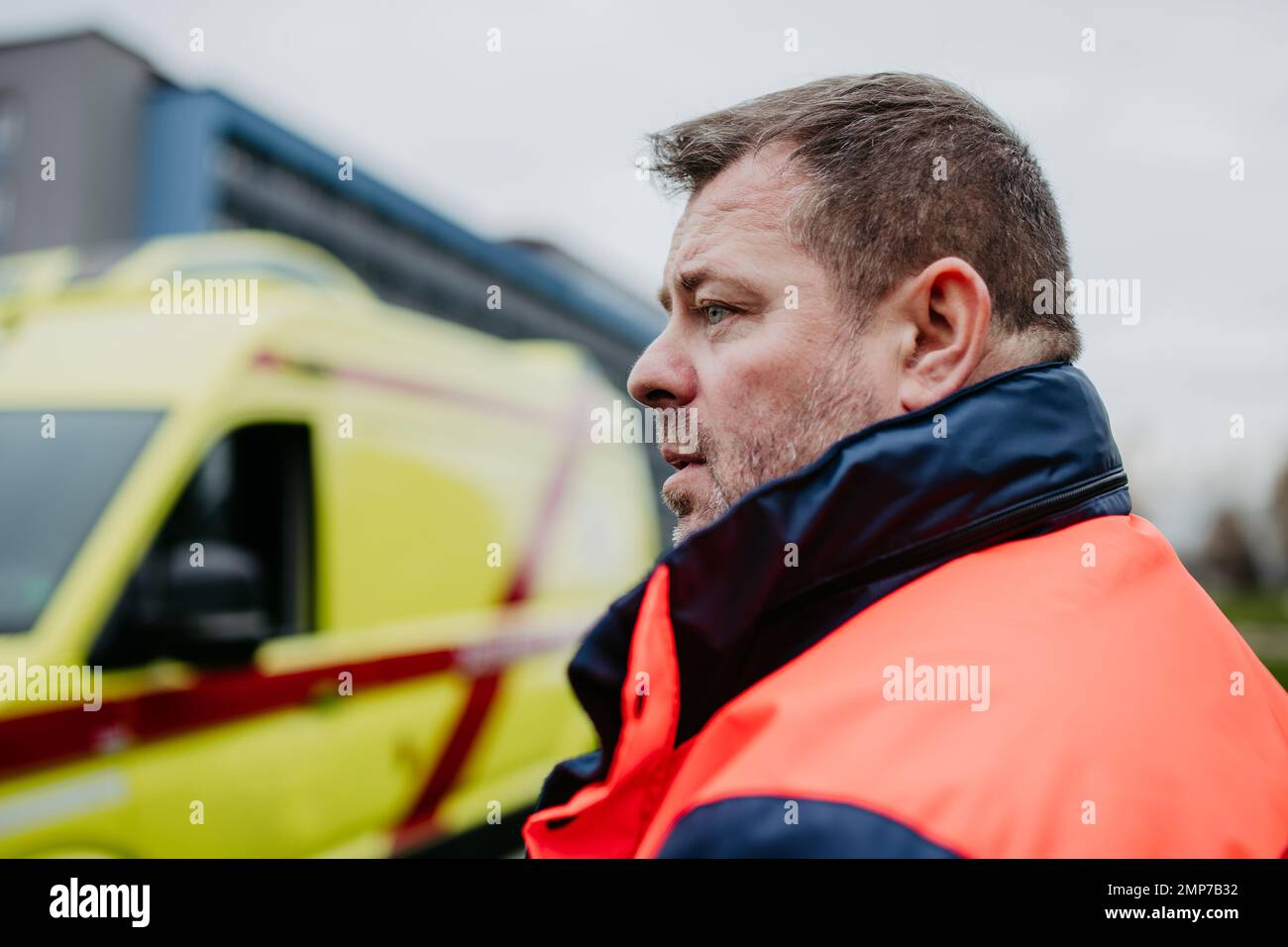 Portrait of rescuer standing near the ambulance car. Stock Photo