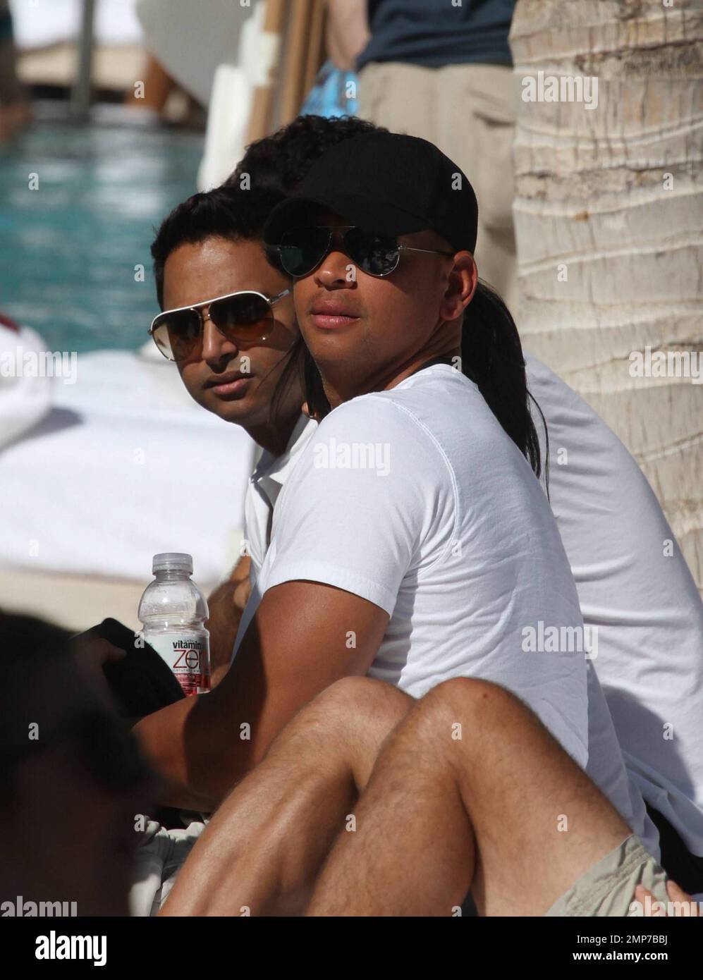Alex Rodriguez enjoys an afternoon of drinks and female attention at the W hotel pool in South Beach.  Earlier in the day Rodriguez attended the Direct TV Celebrity Beach Bowl with his manager Guy Oseary.  Miami, FL 2/6/2010 Stock Photo