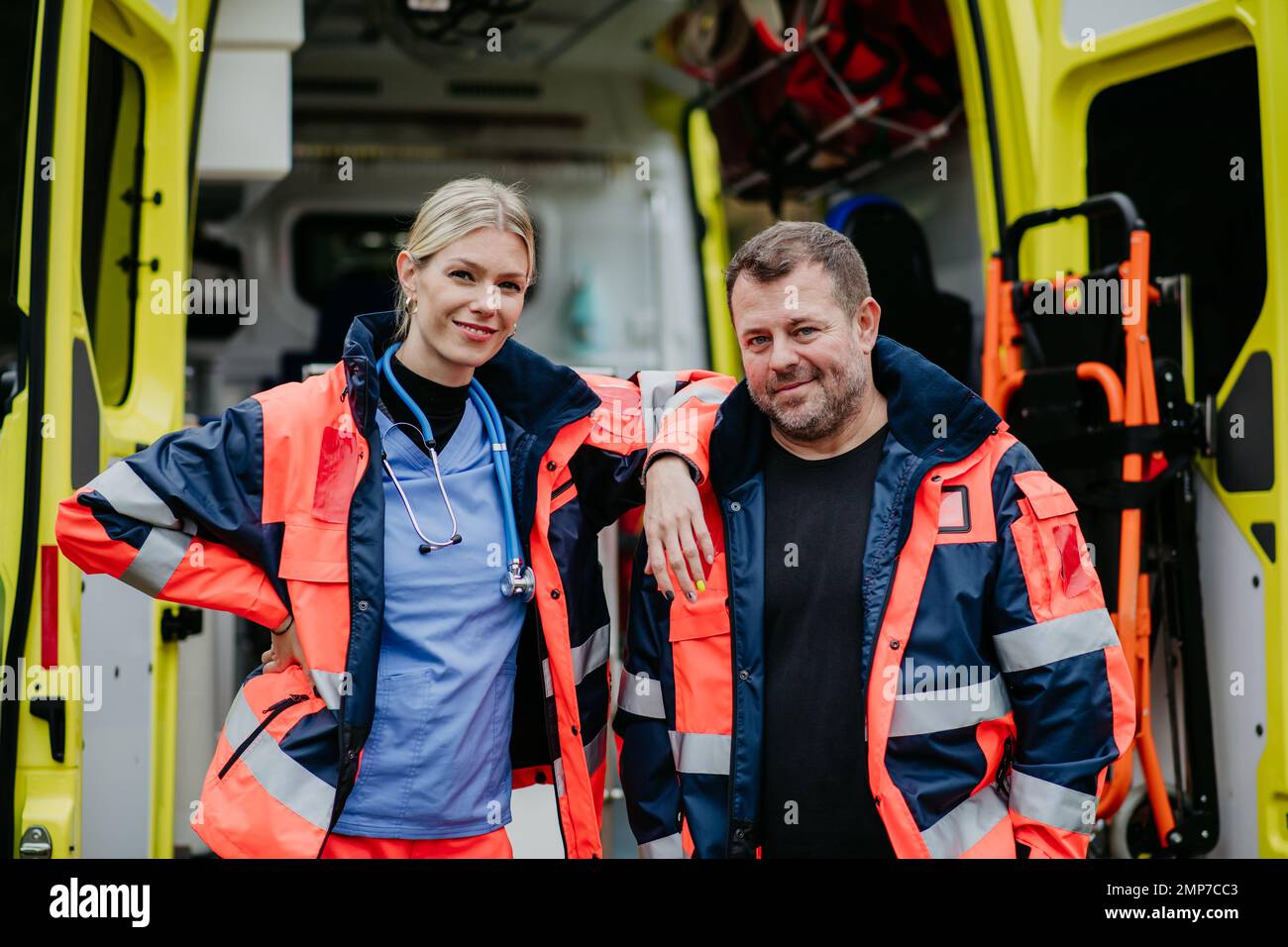 Portrait of rescuers in front of ambulance car. Stock Photo
