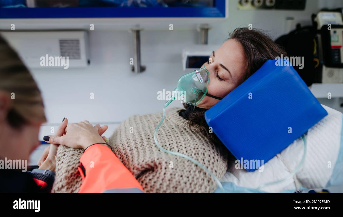 Close-up of examining patient, preparing her for transport. Stock Photo