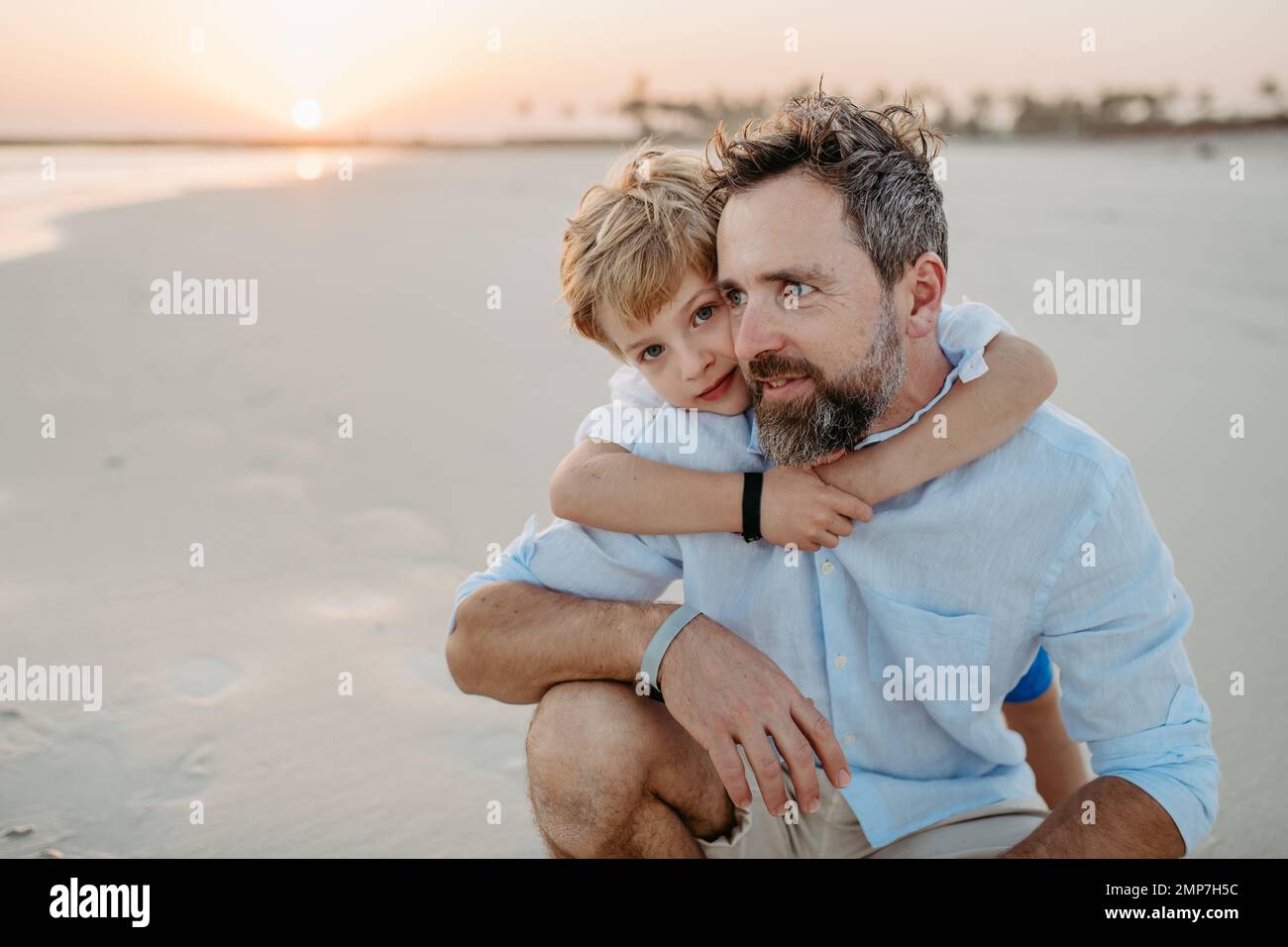 Father with his son enjoying together time at sea. Stock Photo