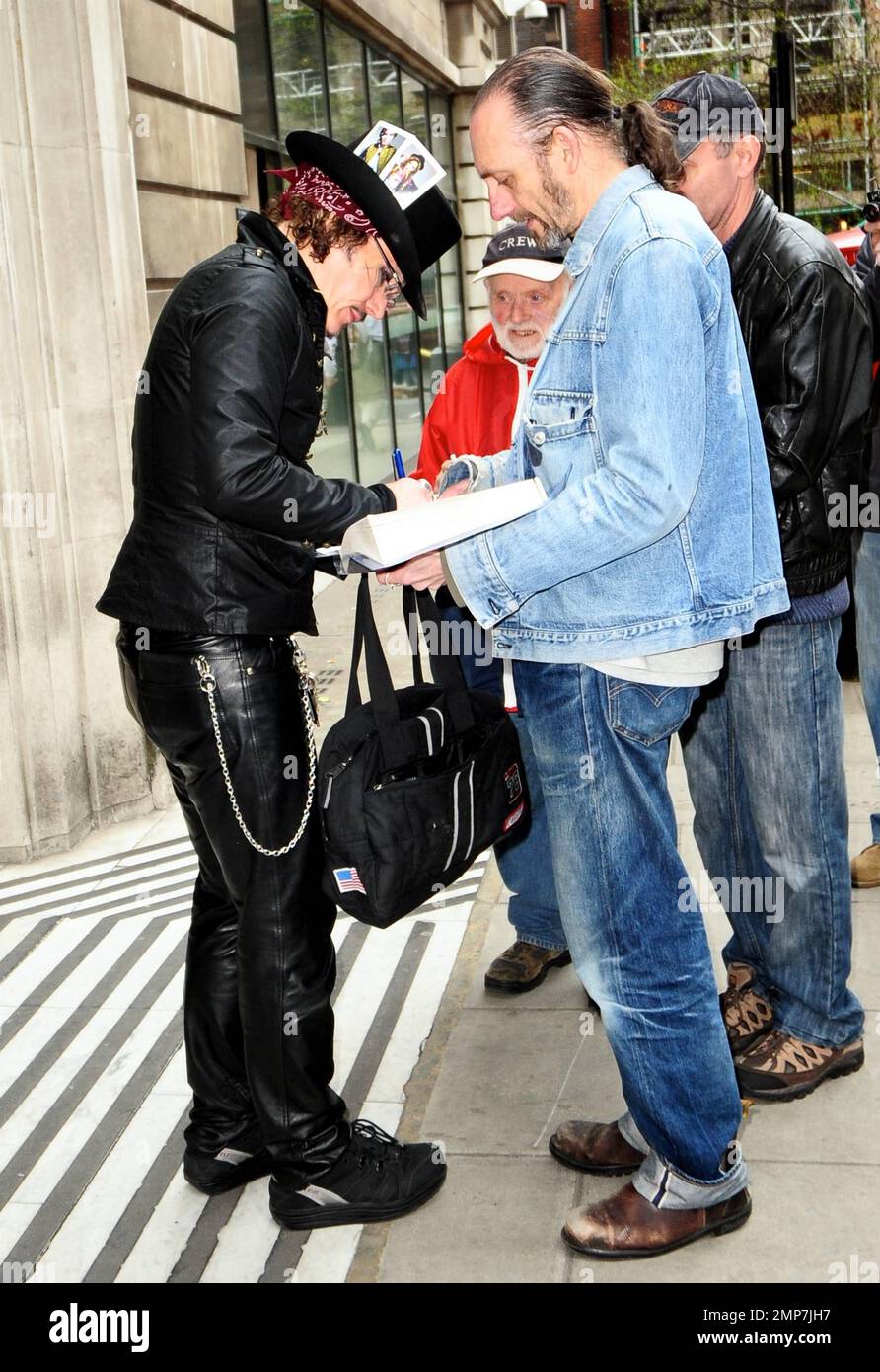 Wearing an all-black outfit complete with a top hat accented with two ...