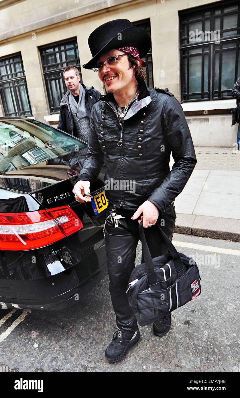 Wearing an all-black outfit complete with a top hat accented with two ...