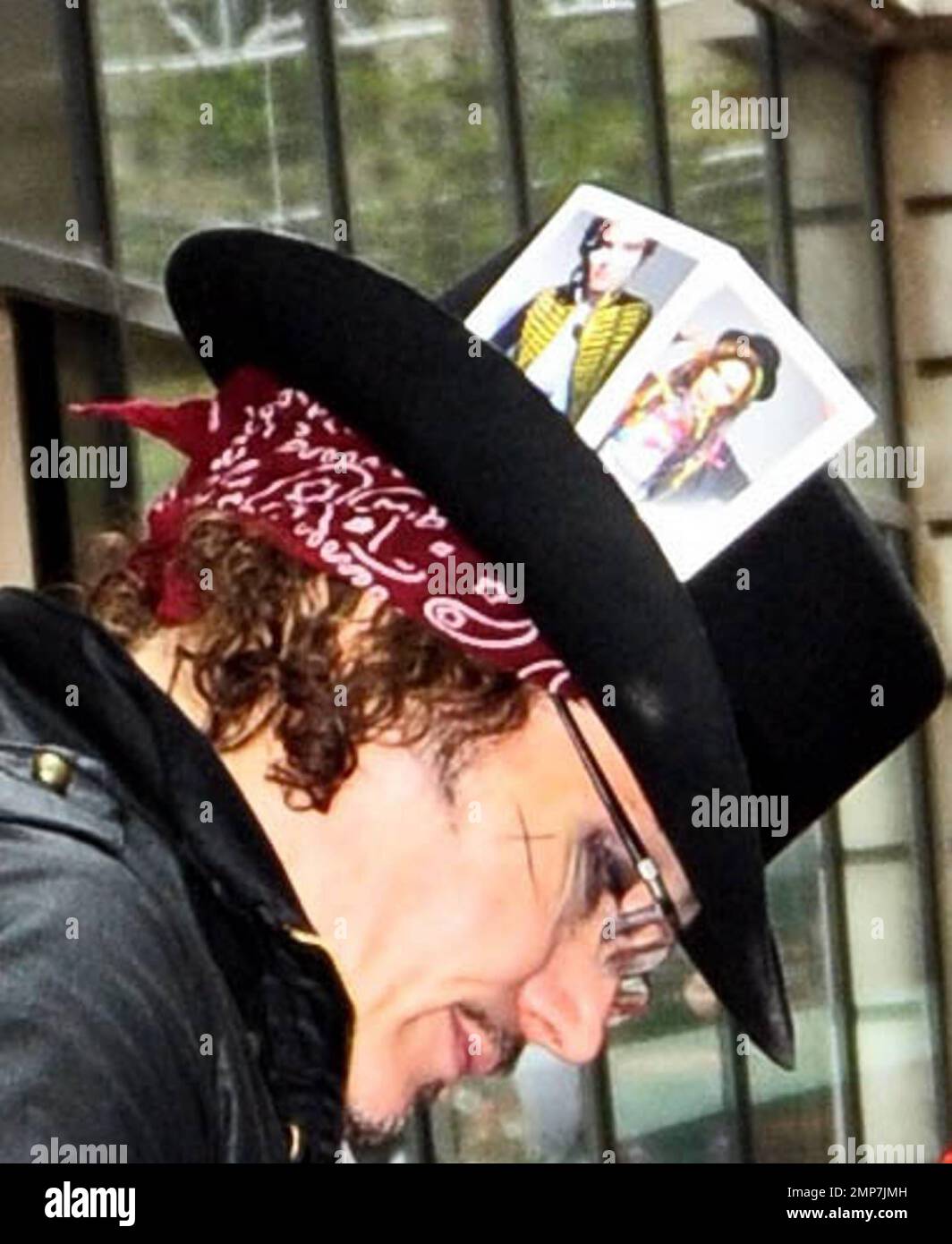 Wearing an all-black outfit complete with a top hat accented with two ...