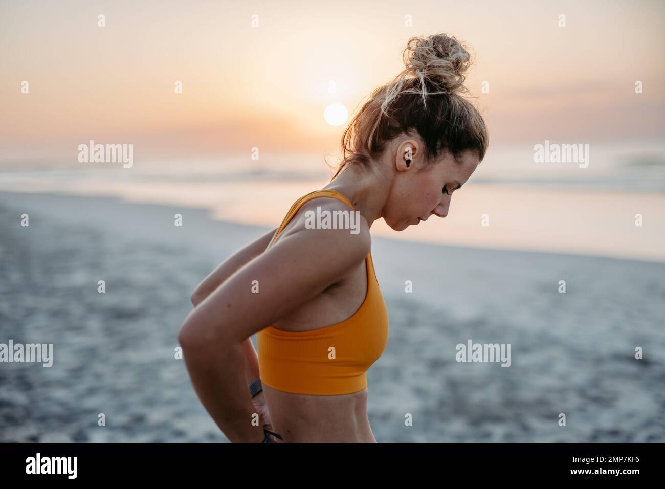 Close-up of young sportive woman at beach. Stock Photo