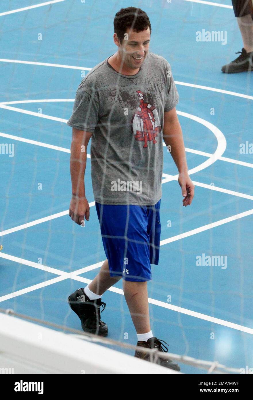 Actor Adam Sandler enjoys some downtime by playing basketball on the