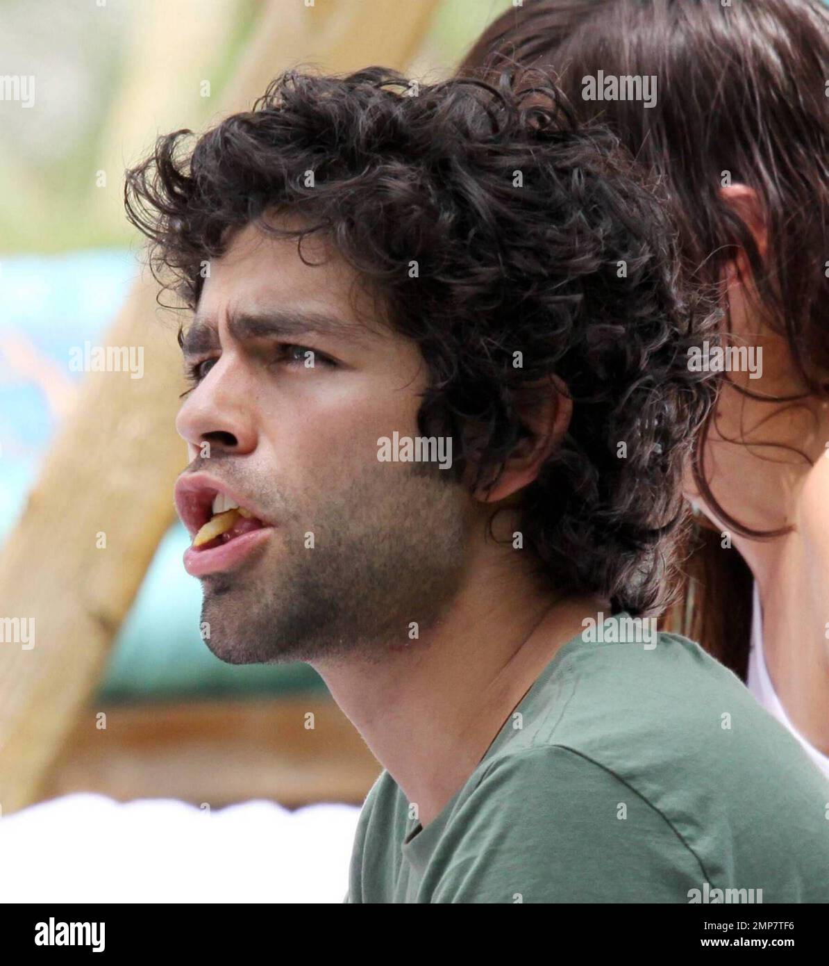Adrian Grenier and his "entourage" lounge poolside. The actor is in
