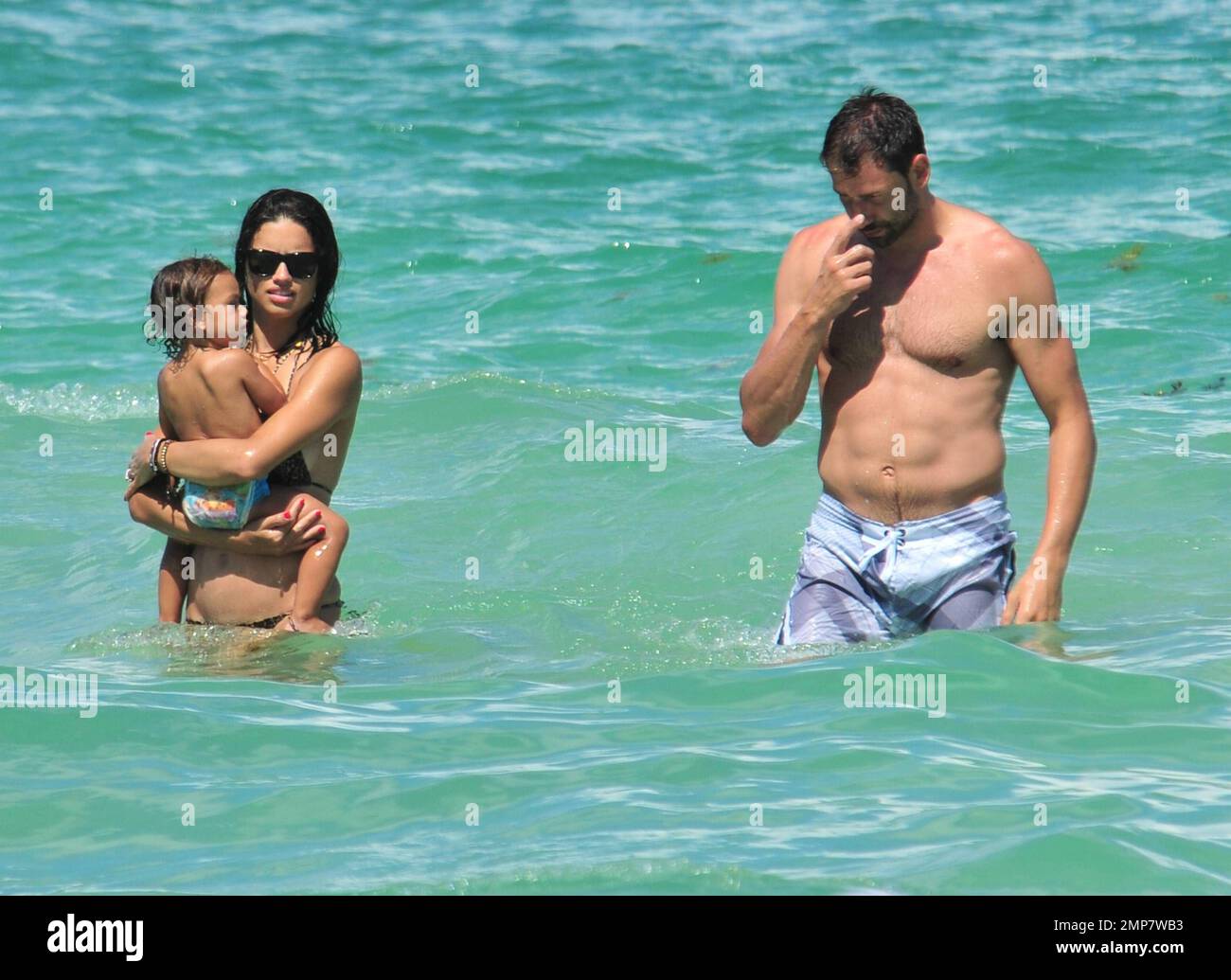Adriana Lima, Daughter Valentina And Husband Marko Jaric have fun in the surf on Miami Beach, FL, 31st July 2011. Stock Photo