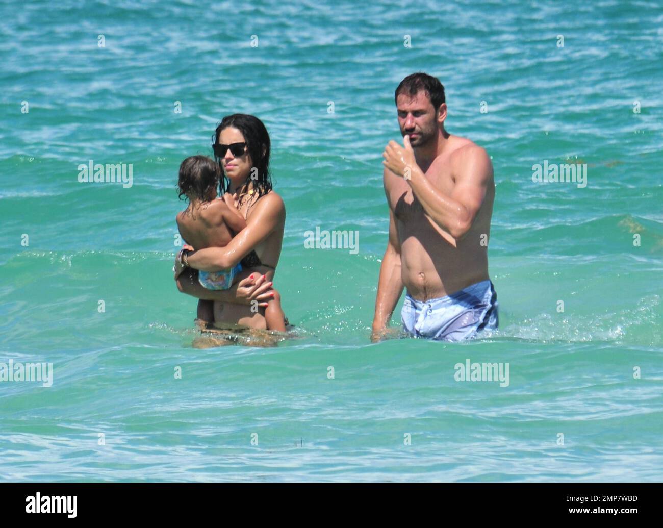 Adriana Lima, Daughter Valentina And Husband Marko Jaric have fun in the surf on Miami Beach, FL, 31st July 2011. Stock Photo