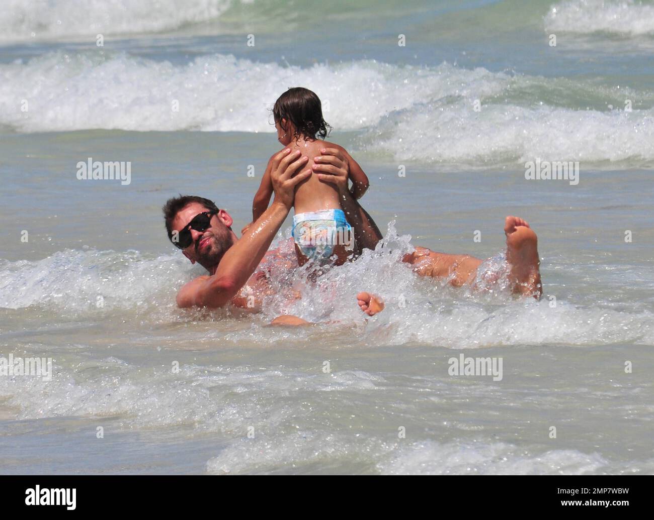 Adriana Lima, Daughter Valentina And Husband Marko Jaric have fun in the surf on Miami Beach, FL, 31st July 2011. Stock Photo