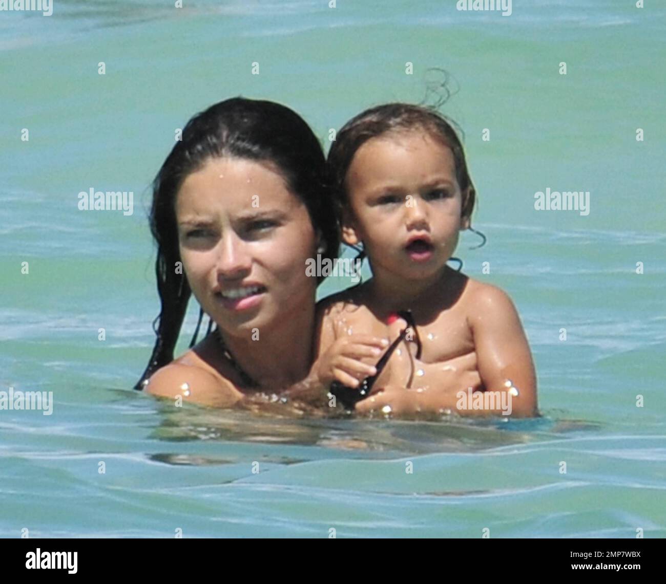 Adriana Lima, Daughter Valentina And Husband Marko Jaric have fun in the surf on Miami Beach, FL, 31st July 2011. Stock Photo