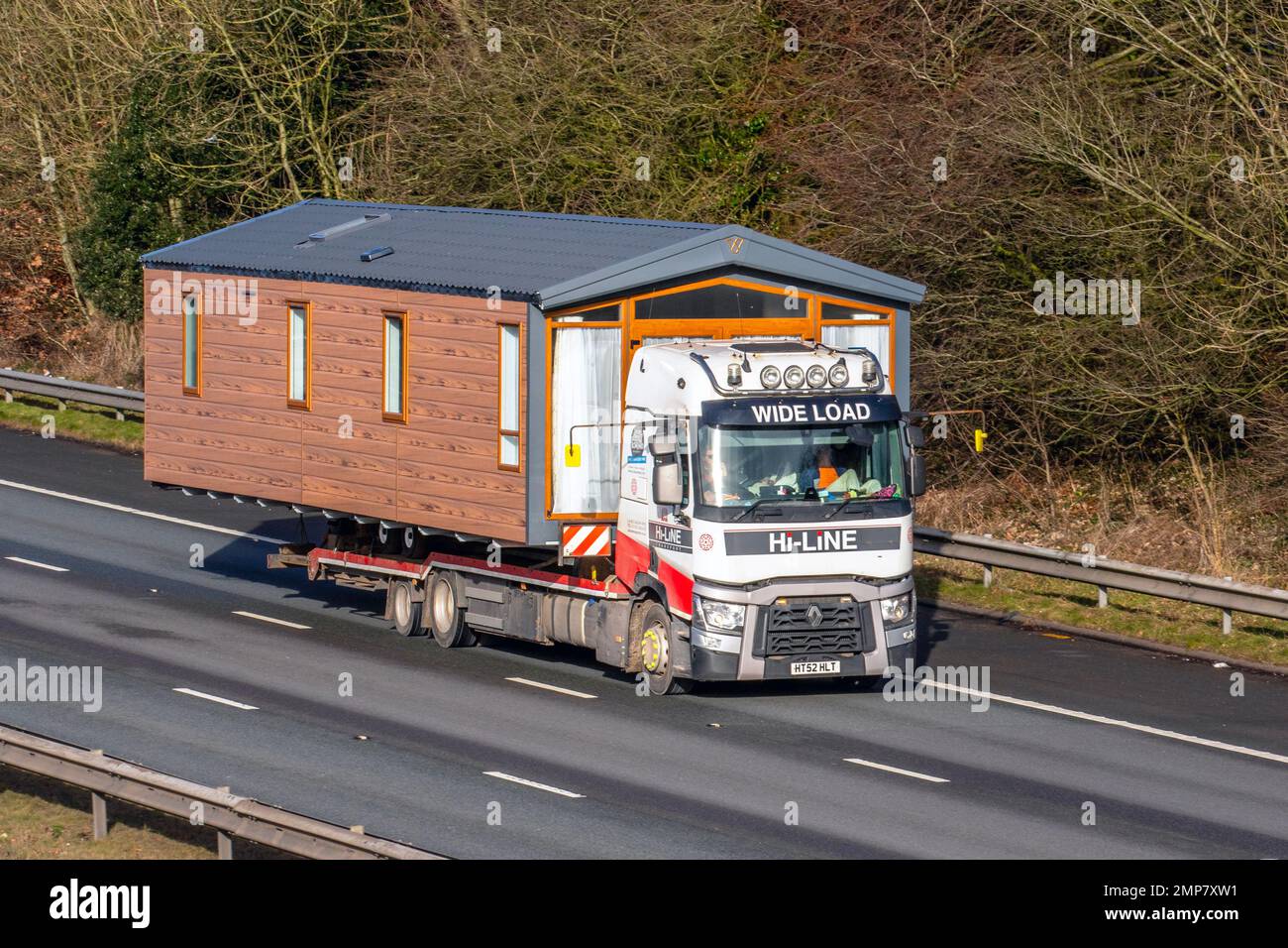 Hi-Line Caravan Transport Ltd  2014 Renault Truck 12777cc Flatbed Diesel Lorry; travelling on the M61 motorway, UK Stock Photo