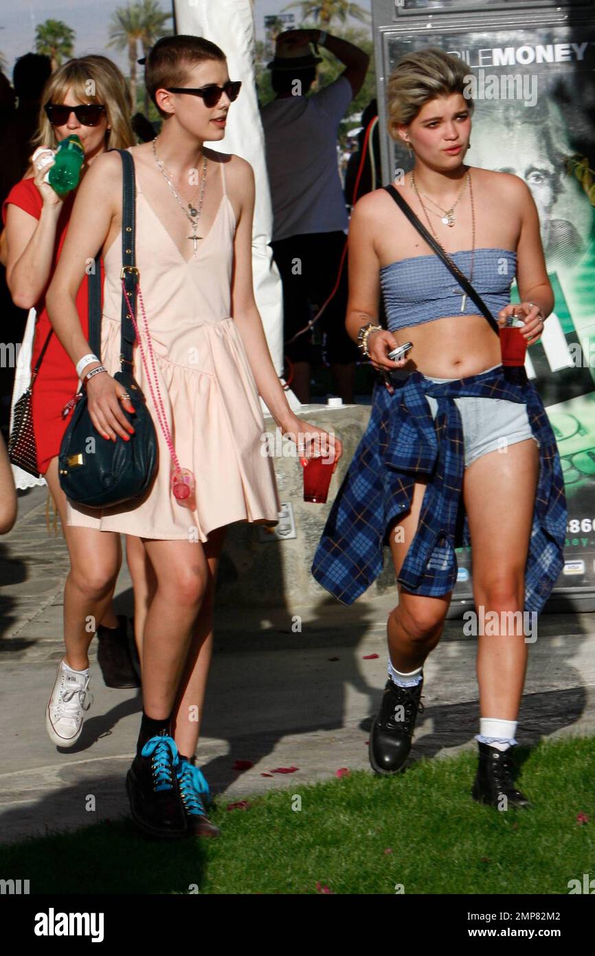 Model Agyness Deyn sports a shaved head, pink dress and Doc Martens as she  hangs out with tube top-clad friend Pixie Geldof at Day One of the  Coachella Music and Arts Festival