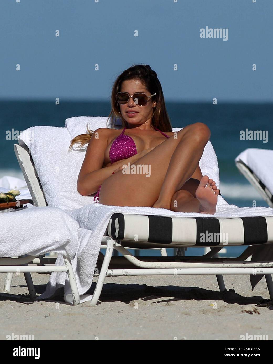 Miss Venezuela 2002 Aida Yespica shows off her amazing beach body in a pink  bikini during a day on the beach while on holiday in Miami Beach, FL. 12th  December 2011 Stock