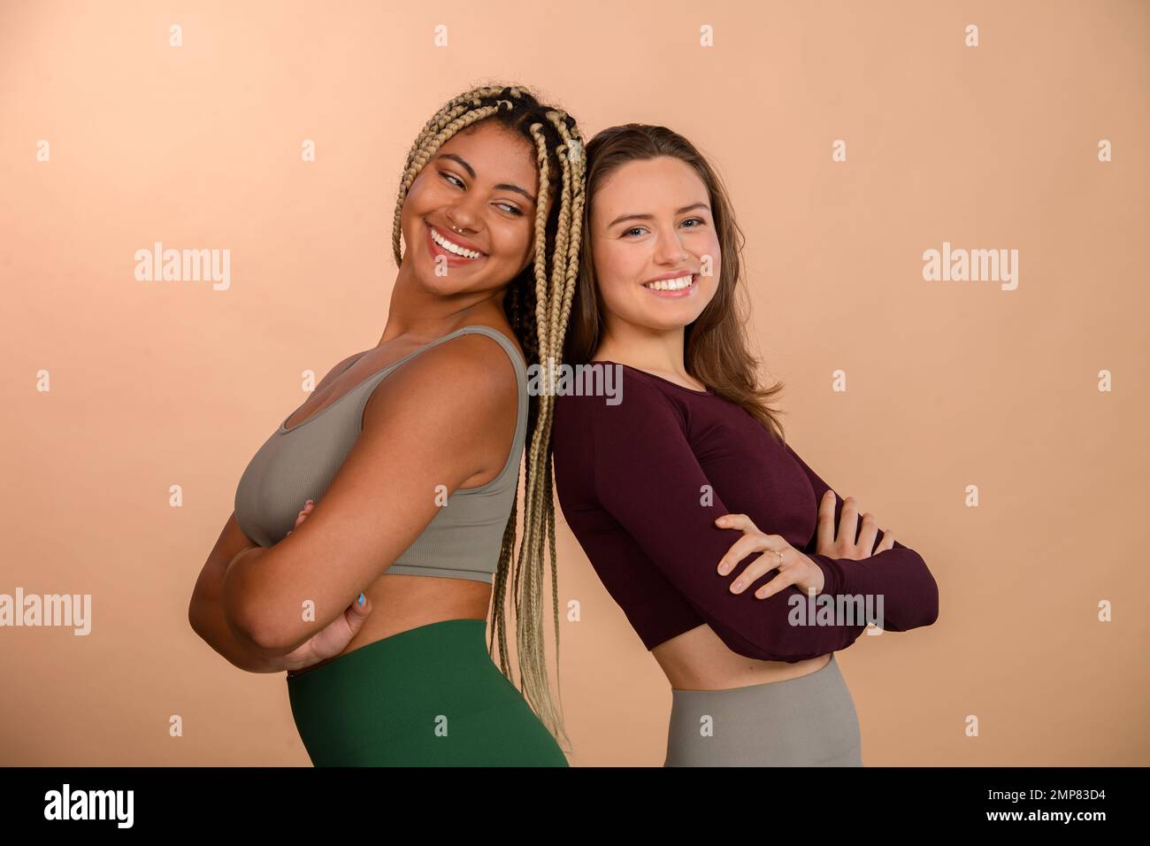 Studio portrait of two young friends in sportive clothes. Stock Photo