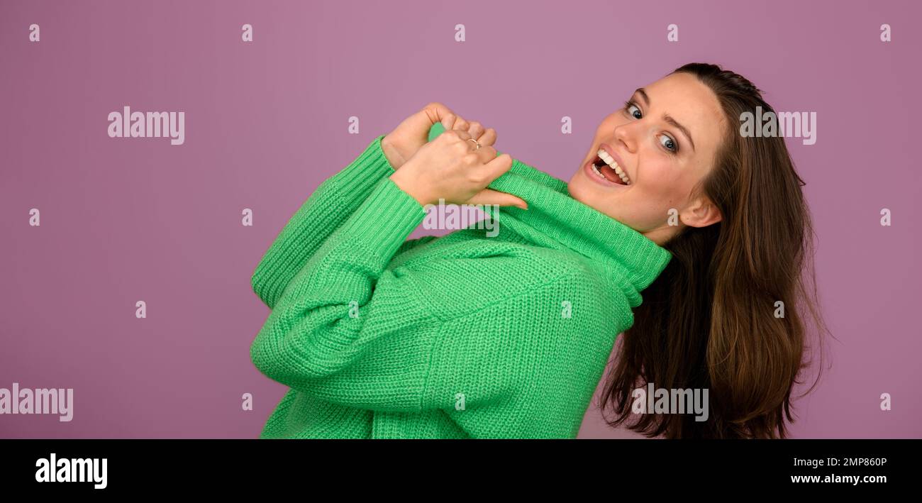 Young woman posing in sweater during studio shooting. Stock Photo