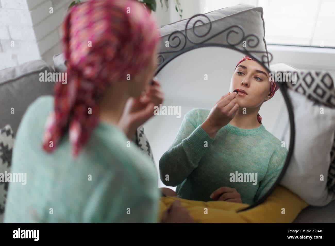Beauty routine of young woman with cancer. Stock Photo