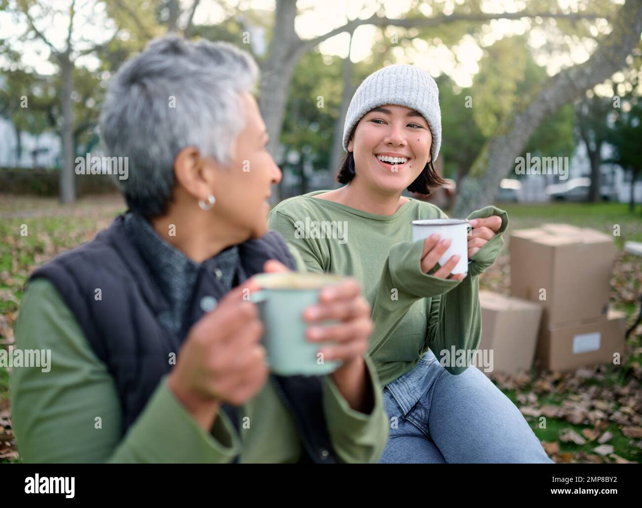 Coffee, break and volunteer relax during community, cleanup and project in a park, happy and bonding. Charity, environment and recycling friends Stock Photo