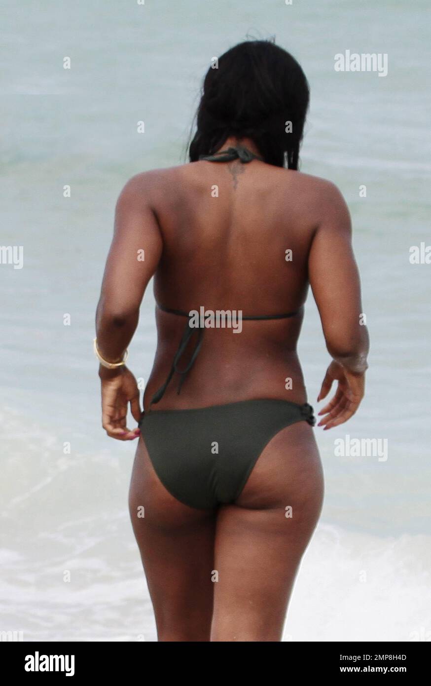 Alexandra Burke shows off her bikini clad body in a military green two  piece as she takes a dip in the ocean in Miami Beach, FL. 26th June 2012  Stock Photo - Alamy