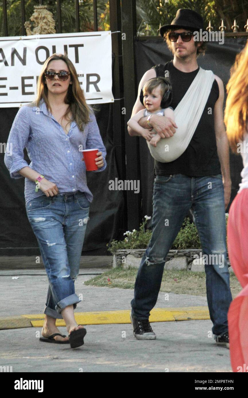 Actress Alicia Silverston along with husband Christopher Jarecki and 11 month old son Bear Blu was spotted at the 2012 Coachella Music Festival. Alicia wore a blue top with rolled-up blue jeans and flip flops whilst Christopher carried their son in a baby sling. Stylish Bear Blu was seen wearing headphones. Indio, CA. 21st April 2012. Stock Photo