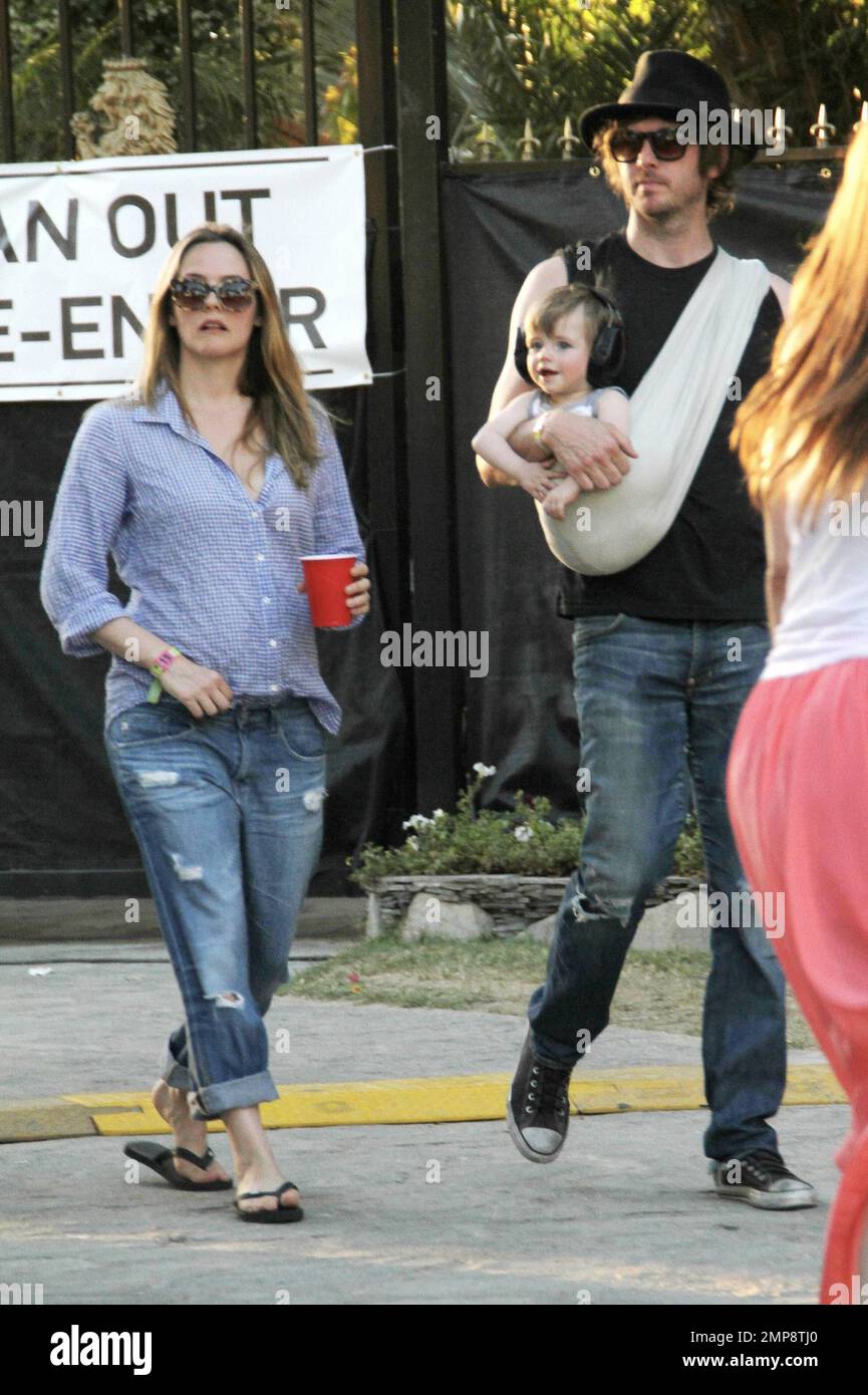 Actress Alicia Silverston along with husband Christopher Jarecki and 11 month old son Bear Blu was spotted at the 2012 Coachella Music Festival. Alicia wore a blue top with rolled-up blue jeans and flip flops whilst Christopher carried their son in a baby sling. Stylish Bear Blu was seen wearing headphones. Indio, CA. 21st April 2012.  . Stock Photo