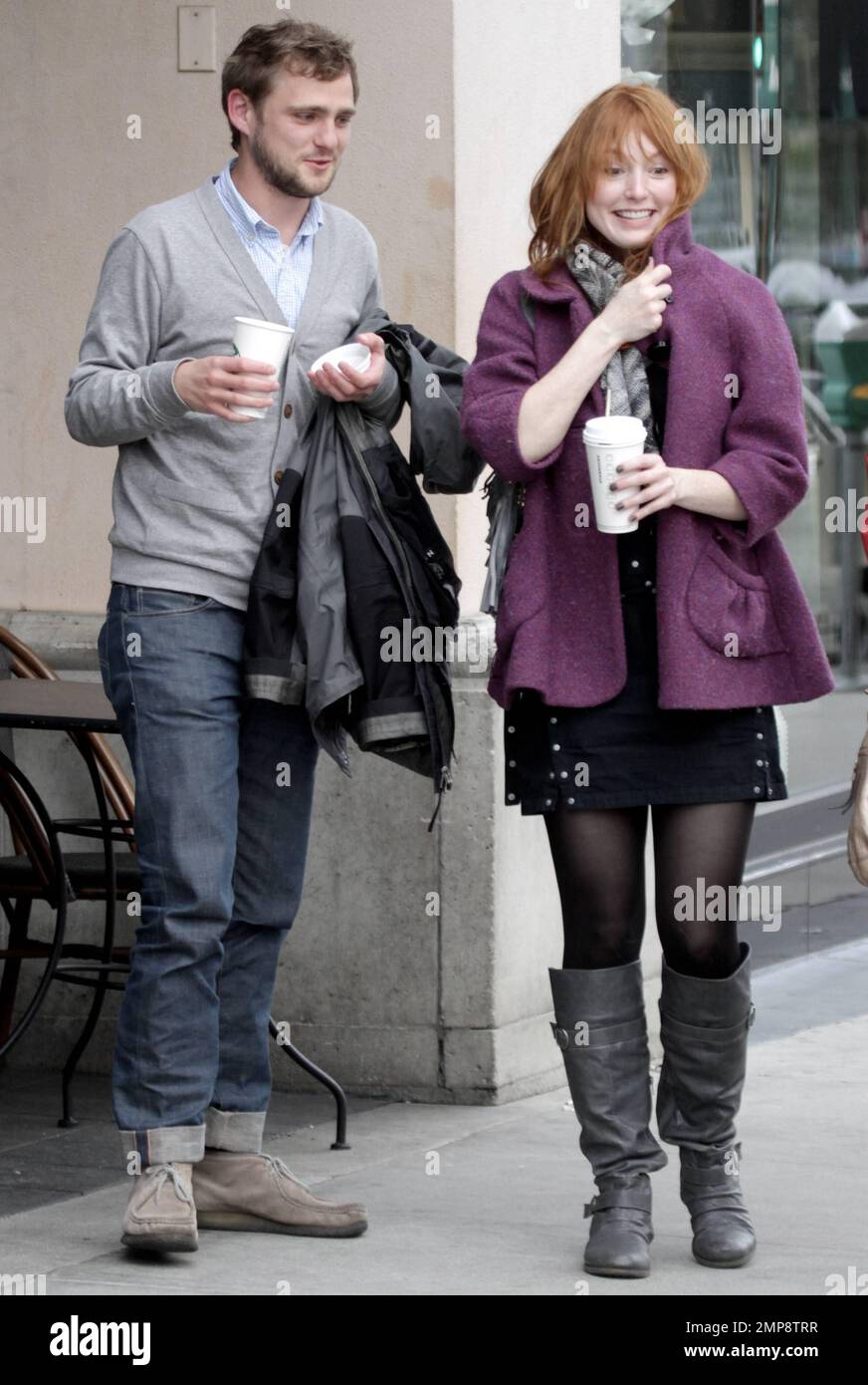 EXCLUSIVE!! Actress Alicia Witt was seen wearing a black dress with a purple jacket, black tights, a grey scarf and grey boots a she exits a Starbucks coffee in Beverly Hills. According