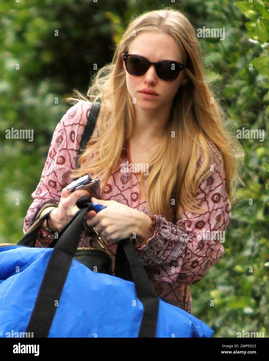 EXCLUSIVE!! In a pair of black combat boots that she's been seen wearing  around lately, tight black jeans and a flouncy top actress Amanda Seyfried,  25, appears a bit glum as she