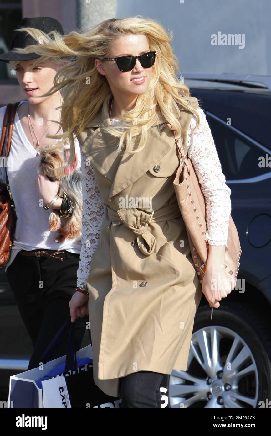 Showing off her long blonde locks, actress Amber Heard looks lovely in a  tan sleeveless coat and lace top paired with black pants as she leaves a  hair salon in Los Angeles,