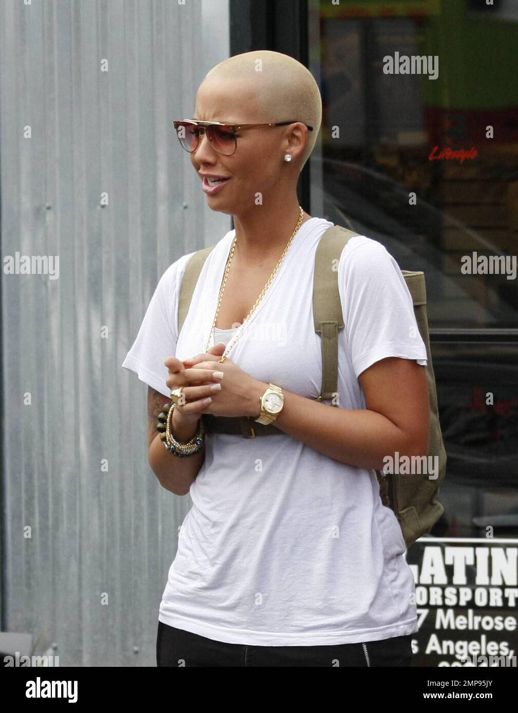 Ex-girlfriend of musician Kanye West, model and socialite Amber Rose shows off her busty figure in a white top as she films scenes for a reality show at Platinum Motorsports. Los