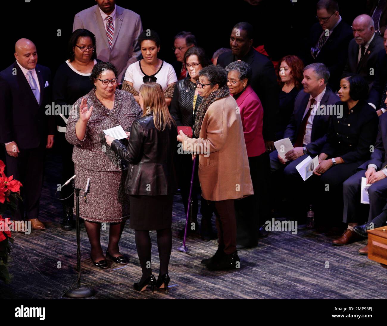 Dana Burley, third from left, takes the oath of office during a swearing-in  ceremony for the Assembly in Trenton, N.J., Tuesday, Jan. 9, 2018. New  Jersey's 120-member Legislature has formally been sworn