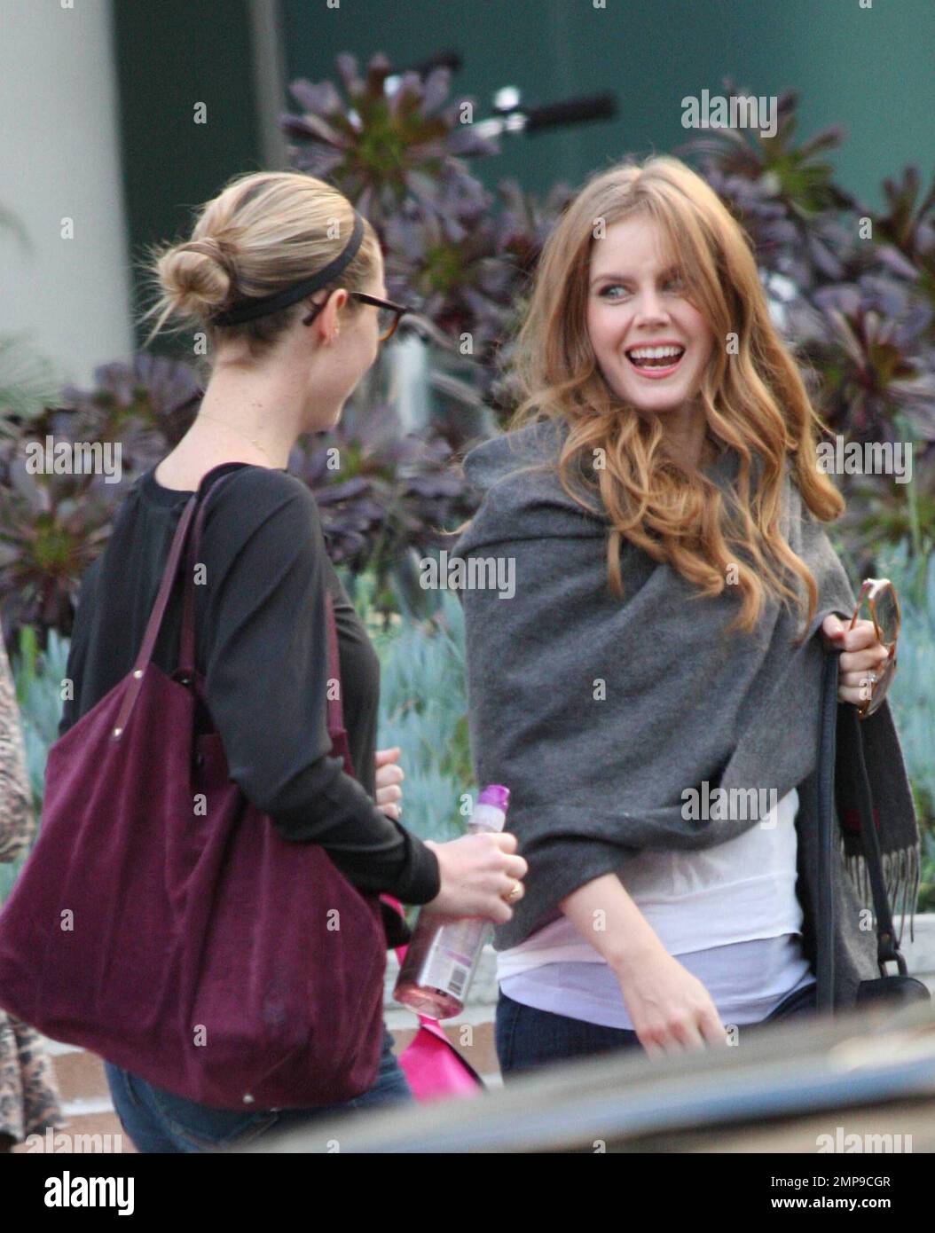 Actress Amy Adams chats with a friend as she leaves the studios of \, image size:1054x1390